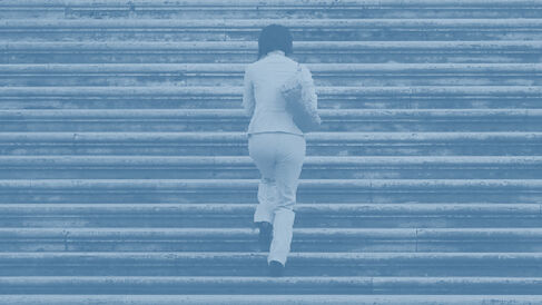 A person walking up a large flight of stone steps