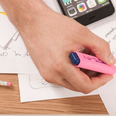 A photo of someone editing hand-written notes, highlighting texts and working across their phone, paper, and computer
