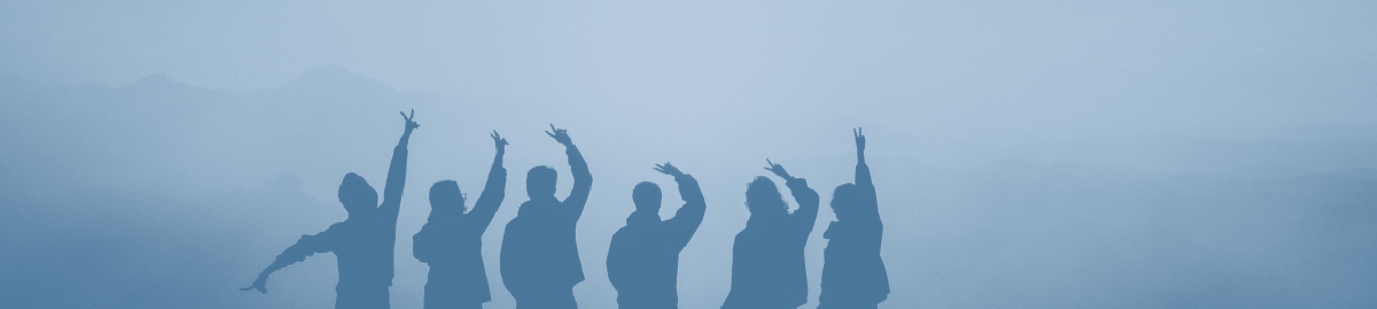 A team of people cheering together