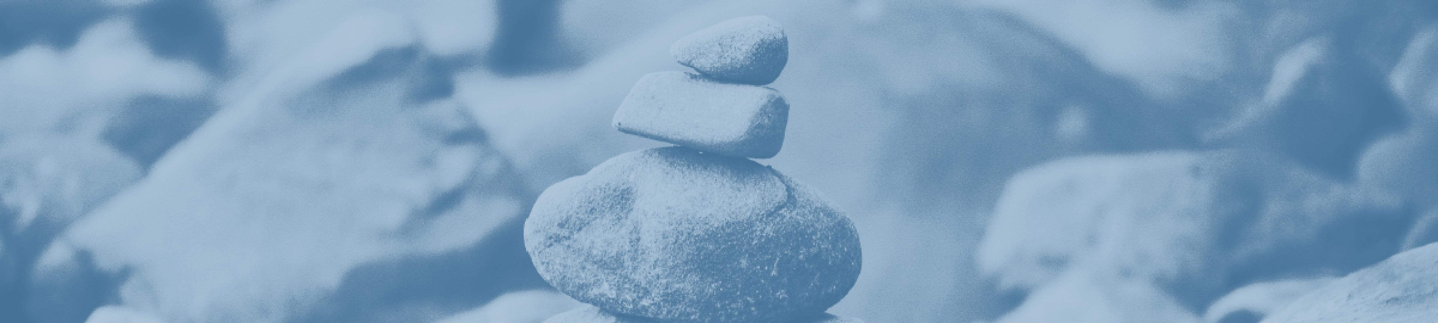 A small pile of pebbles balanced on a beach